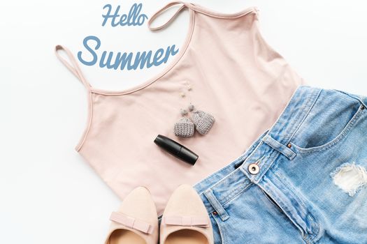 Hello summer concept. Female clothes, and accessories layout on white background. Flat lay. Top View