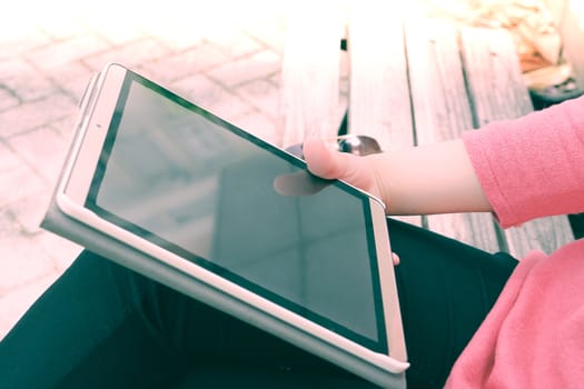 The tablet computer is holding on young student women hand