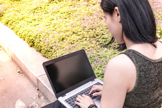 A laptop computer is using for surfing internet by student women