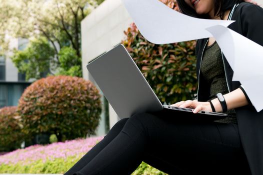 A student woman is surfing internet in laptop computer