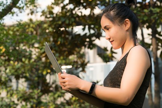 A woman is holding laptop computer to surfing internet