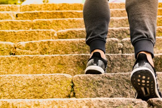 A man climbing the stone steps to success