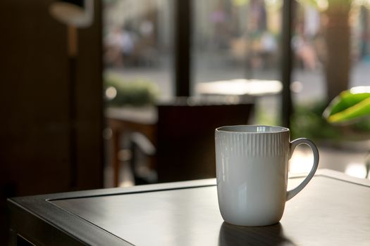 A mocha or cappuccino hot coffee in white cup on the wooden table