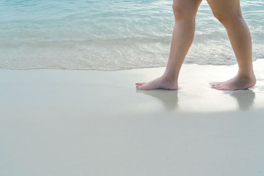 Beach travel - blur girl's walking on the white sand beach, vacation and relax - soft skin filter