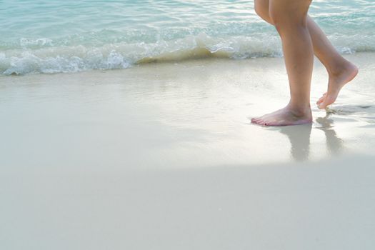 Beach travel - blur girl's walking on the white sand beach, vacation and relax - soft skin filter