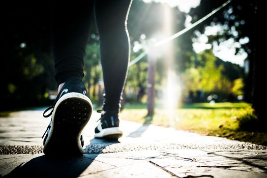 close up of girl shoe while walking in the park, walk for life concept