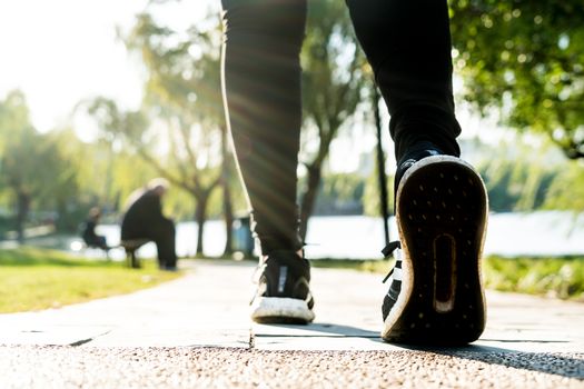 close up of girl shoe while walking in the park, walk for life concept