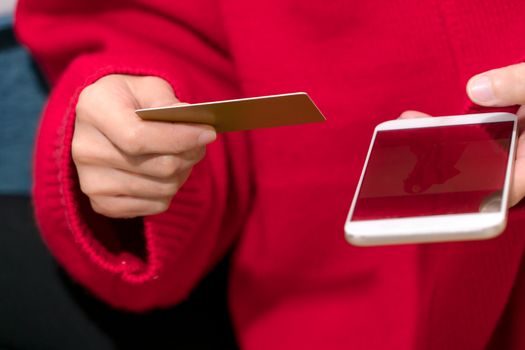 the woman is holding the credit card for online shopping for family new year gift