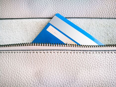 the credit card in the zipper of the wallet