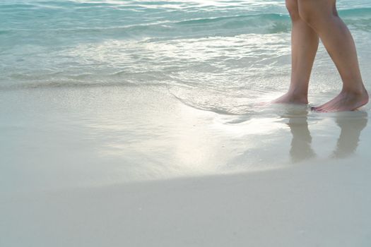 Beach travel - girl walking on the white sand beach, vacation and relax