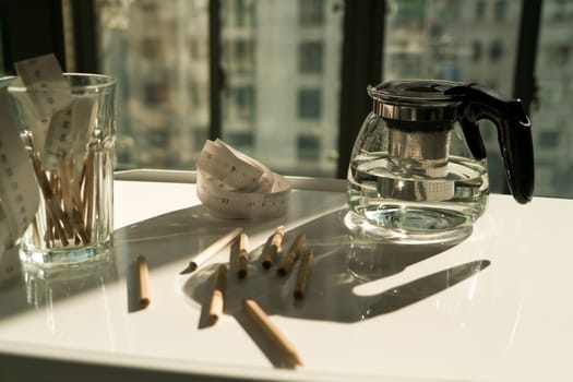 tea pot with measure tape and pencil on the working table, working and rest concept