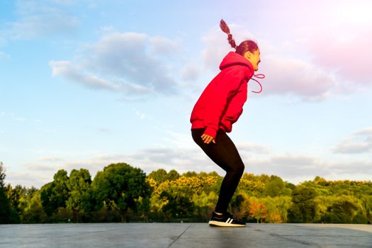 happy young woman is jumping over the garden - applier sunbeam