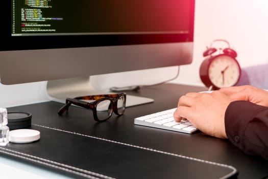 closeup of programmer hand on white keyboard while working