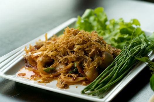 closeup Thai food spicy salad oyster with fried garlic and vegetable