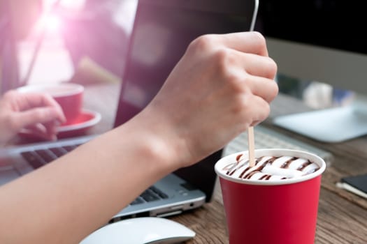 focus on the woman hand mixing the coffee/ soft