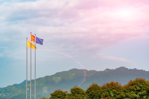 The sunbeam sky with three color flag blowing in the wind