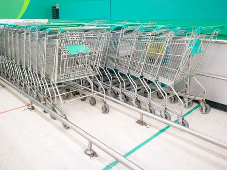 the parking lot of steel trolley or shopping cart in supermarket