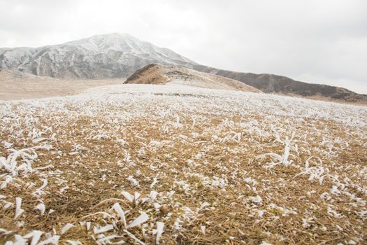 Mount Aso and Kusasenri in winter. covered by golden yellow grassland - Kumamoto, Japan