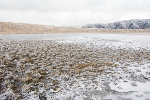 Mount Aso and Kusasenri in winter. covered by golden yellow grassland - Kumamoto, Japan