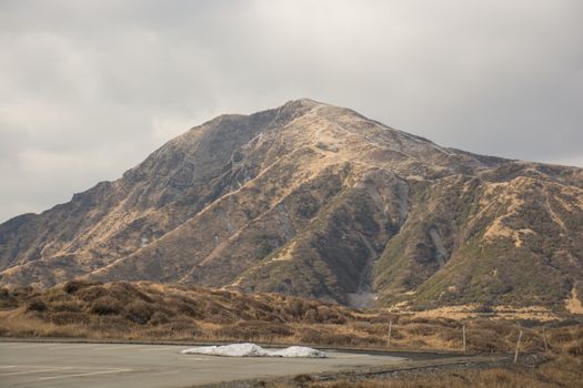 Mount Aso and Kusasenri in winter. covered by golden yellow grassland - Kumamoto, Japan