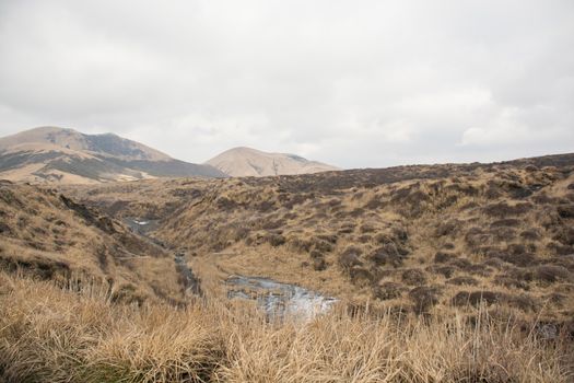 Mount Aso and Kusasenri in winter. covered by golden yellow grassland - Kumamoto, Japan