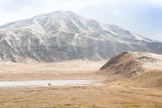 Mount Aso and Kusasenri in winter. covered by golden yellow grassland - Kumamoto, Japan