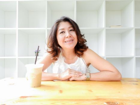 Beautiful woman smiling happy against white background.
