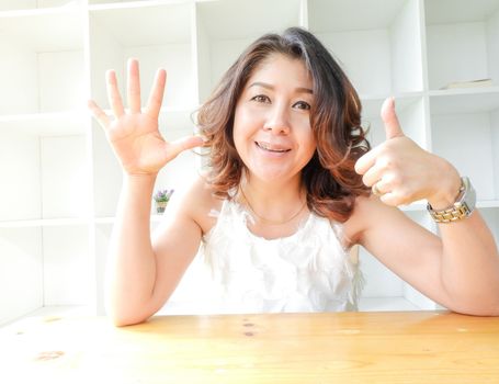 Beautiful woman smiling happy against white background.
