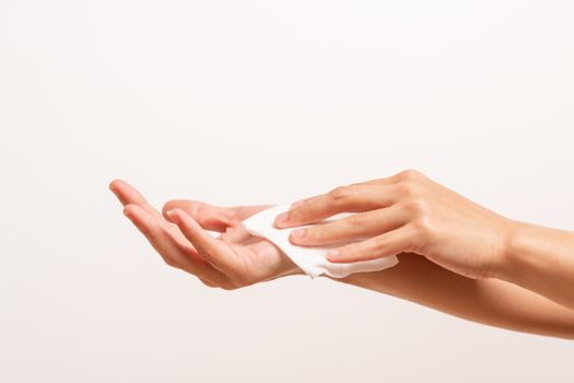 Woman cleaning her hands with white soft tissue paper. isolated on a white backgrounds