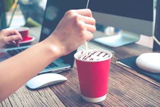 the woman hand mixing the coffee while working at coffee shop/ matte apply