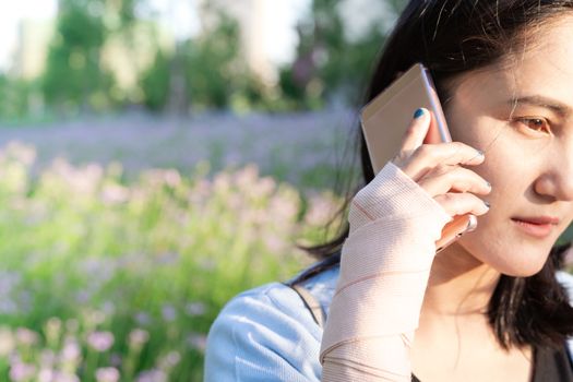 young student women calling on smartphone while wrist hand pain. modern lifestyle concept