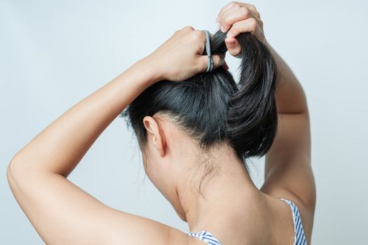 rear view of women tightening the hair, lifestyle concept