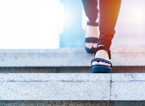 Women step forward to success, business young women is stepping forward on staircase