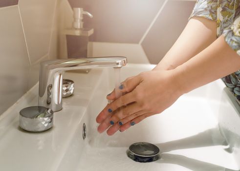 women washing hands under the water fauce. Hygiene concept.