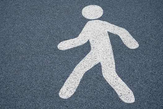 Walk sign, pedestrian street sign on a wet dark asphalt floor