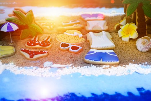 Summer concept of sandy beach, bikini, straw hat, shells and  sunset