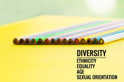 Diversity concept. row of mix color pencil on yellow background with text Diversity, Ethnicity, Equality, Age, Sexual Orientation