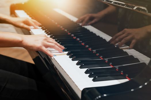 women hand on classic Piano keyboard closeup