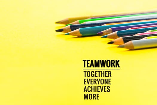 Teamwork concept. group of color pencil on yellow background with word Teamwork, Together, Everyone, Achieves and More