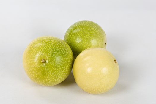 A group of three passion fruit  on a white background