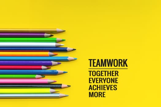 Teamwork concept. group of color pencil on yellow background with word Teamwork, Together, Everyone, Achieves and More