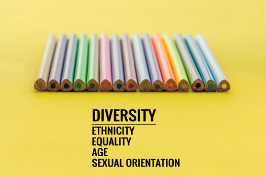 Diversity concept. row of mix color pencil on yellow background with text Diversity, Ethnicity, Equality, Age, Sexual Orientation