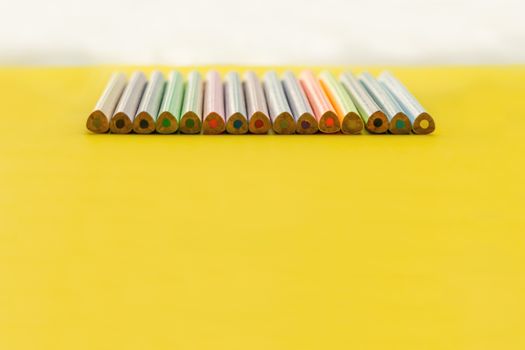 Diversity concept. row of mix color pencil on yellow background