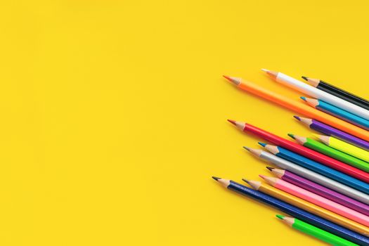 Community communication concept. Group of pencils on the yellow background with copy space