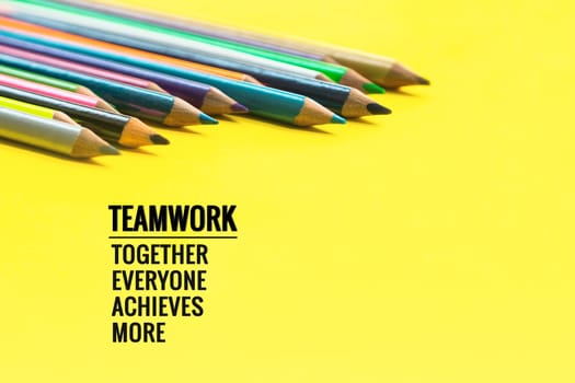 Teamwork concept. group of color pencil on yellow background with word Teamwork, Together, Everyone, Achieves and More