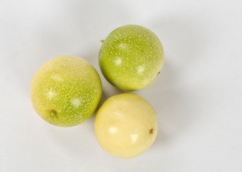 A group of three passion fruit  on a white background