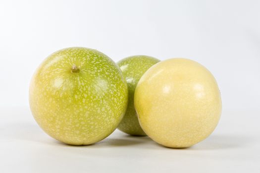 A group of three passion fruit  on a white background