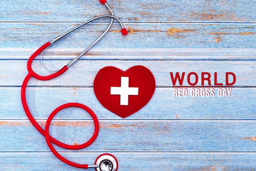 World Red Cross day. Red heart with Stethoscope on wooden table background