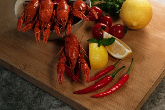 Crayfish or baby Lobster. Red boiled crawfishes on a wooden