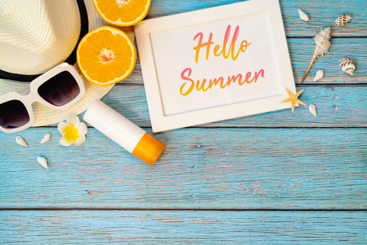 Beautiful summer holiday, Beach accessories, orange, sunglasses, hat and sunblock on wooden backgrounds